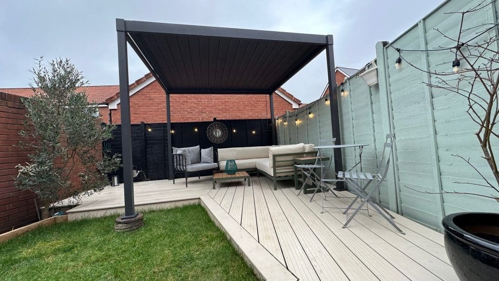 Small garden landscaping in Cranbrook, Exeter with white composite decking and aluminium pergola