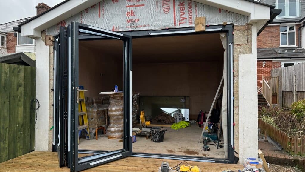 Aluminium bi fold doors on a rear garden garage conversion in Exeter