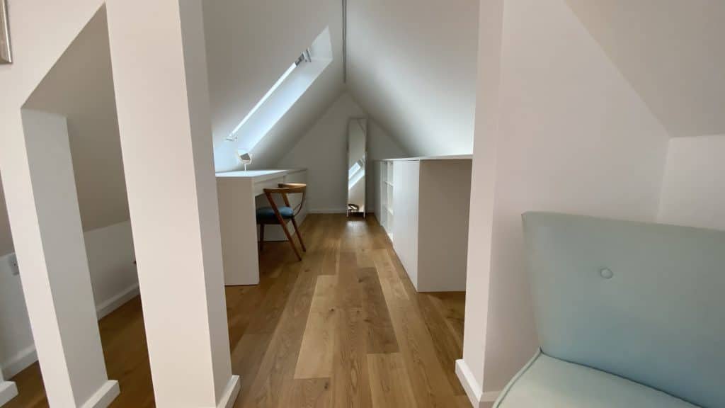 Walk in dressing room in a loft conversion with engineered oak flooring