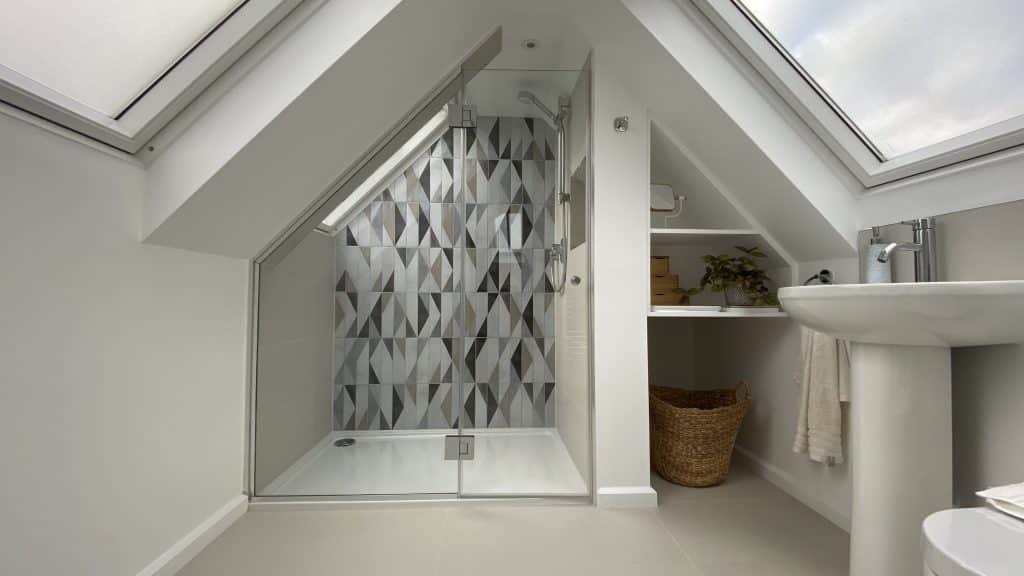 Walk in shower shaped to the loft conversion ceiling