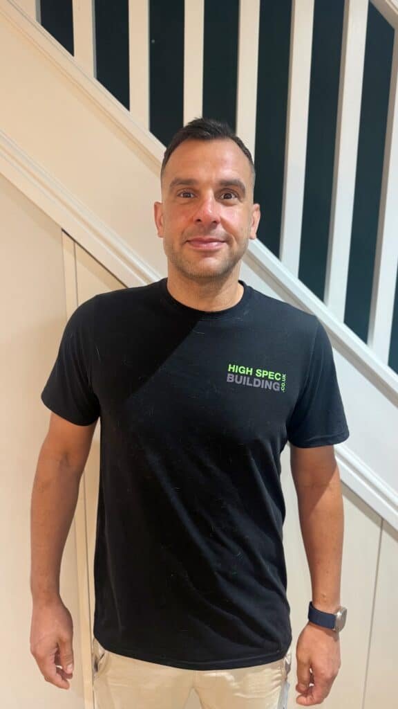 Director at High Spec Building, Standing in front of a staircase