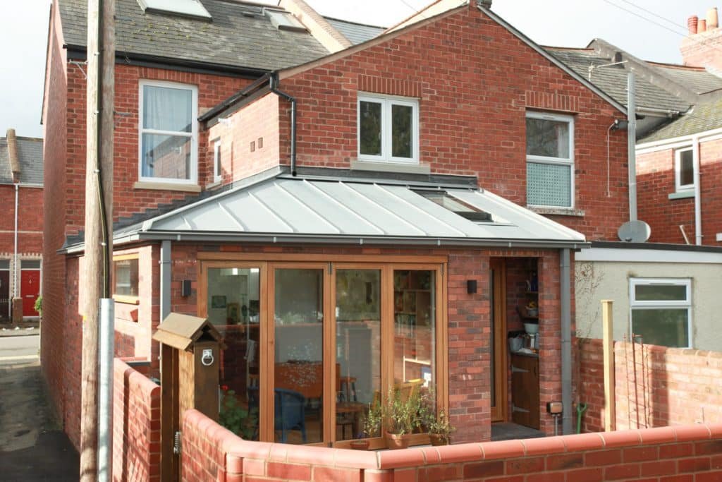 Rear home extension in Exeter with oak windows and zinc roof